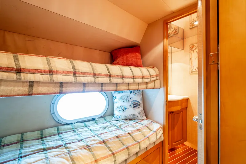 Slide: The Image of Bunk beds in a cozy cabin of a 2000 Hatteras 70 Convertible yacht. - 46