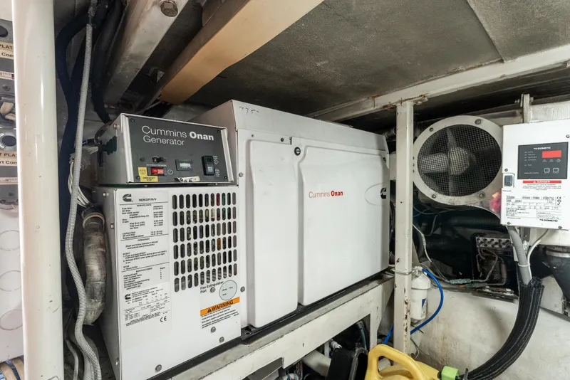 Slide: The Image of Cummins Onan generator in 2000 Hatteras 70 Convertible engine room. - 49