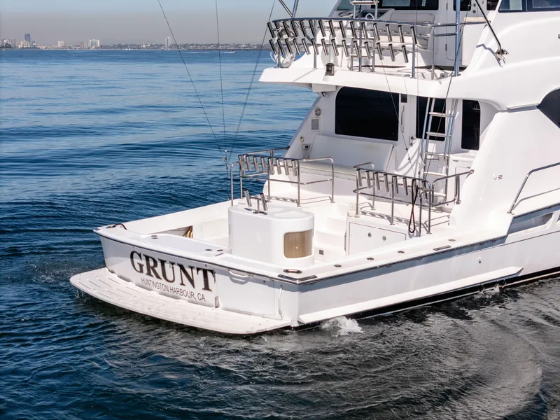 Slide: The Image of Hatteras 70 Convertible yacht, 2000 model, cruising on calm waters, rear view. - 5