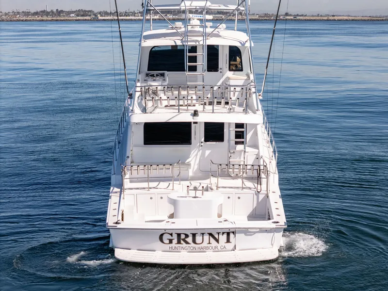 Slide: The Image of Hatteras 70 Convertible yacht, 2000 model, cruising on calm waters, rear view. - 6