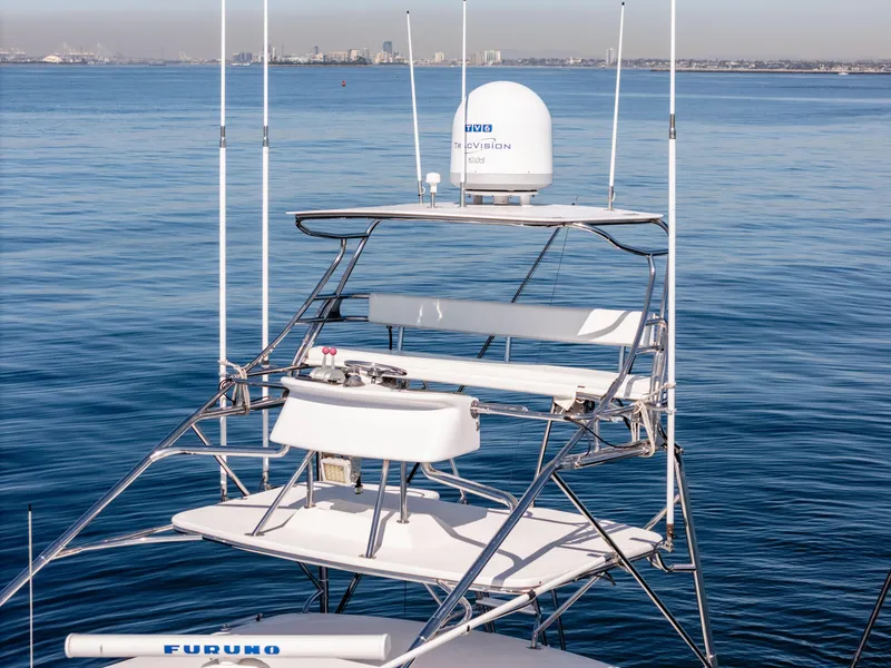 Slide: The Image of Hatteras 70 Convertible 2000 yacht tower with radar, ocean backdrop, clear sky. - 7