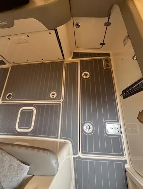 Slide: The Image of 2022 Scout 355 LXF CC boat interior flooring with storage compartments. - 10