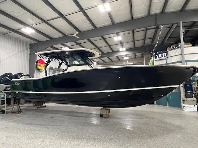Slide: The Image of 2022 Scout 355 LXF CC boat in indoor storage facility. - 11