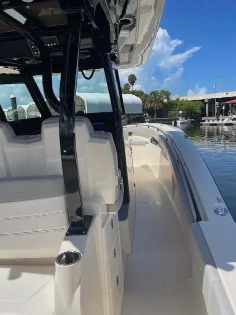 Slide: The Image of 2022 Scout 355 LXF CC boat interior with sleek seating and modern design. - 4