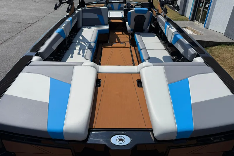 Slide: The Image of 2026 Axis T250 boat interior with blue and gray seating, spacious layout, and modern design. - 12