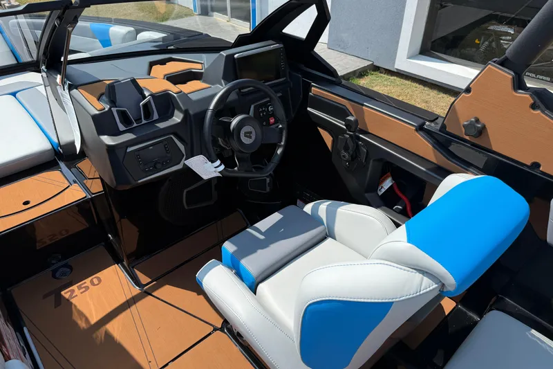 Slide: The Image of 2026 Axis T250 boat interior with modern dashboard and blue-white seating. - 15