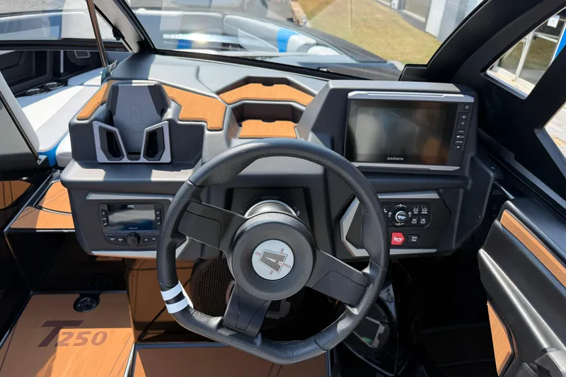 Slide: The Image of 2026 Axis T250 boat dashboard with steering wheel, digital displays, and modern controls. - 16