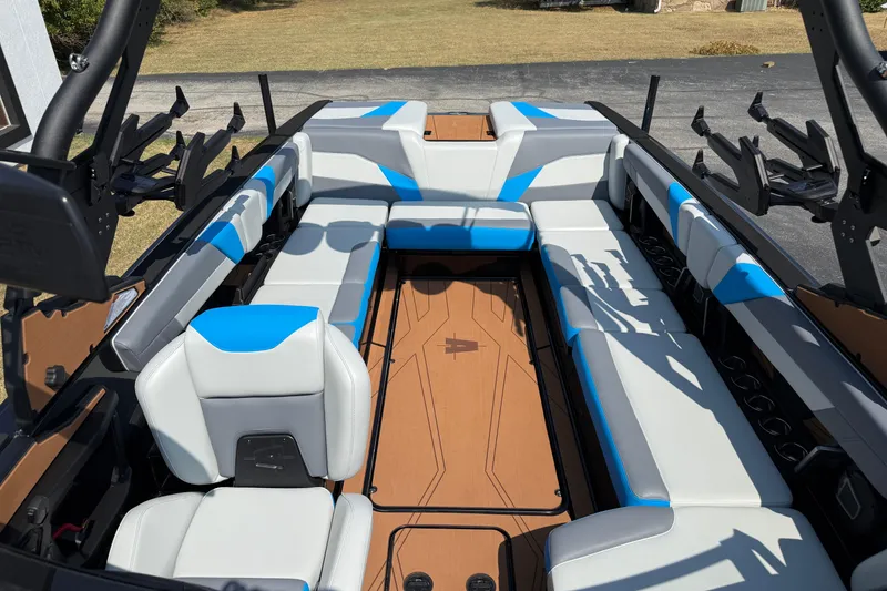 Slide: The Image of 2026 Axis T250 boat interior with blue and white seating, spacious layout, and modern design. - 21