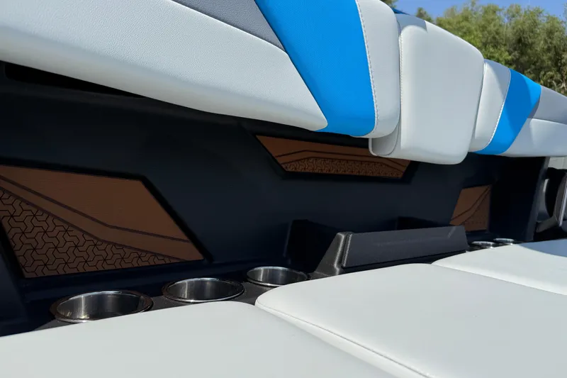 Slide: The Image of 2026 Axis T250 boat interior with blue and white seating and cup holders. - 27