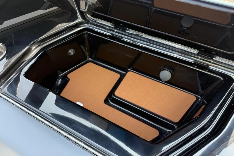 Slide: The Image of Open storage compartment in 2026 Axis T250 boat, featuring sleek black interior design. - 32