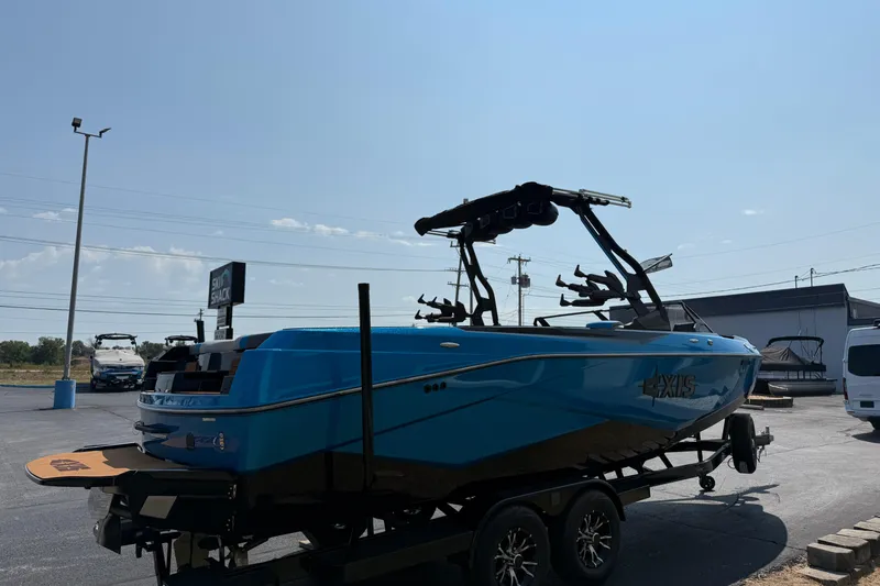 Slide: The Image of 2026 Axis T250 boat in vibrant blue on a trailer, parked outdoors. - 5
