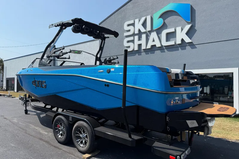 Slide: The Image of 2026 Axis T250 boat in vibrant blue at Ski Shack dealership. - 9