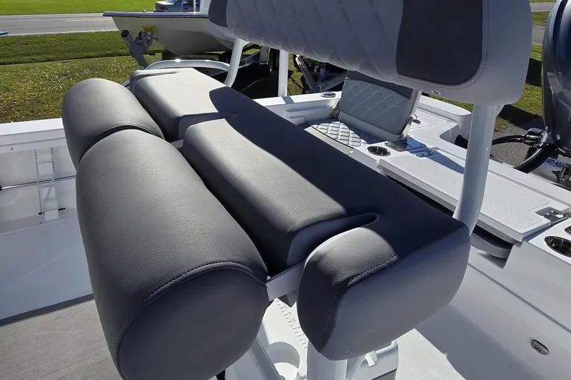 Slide: The Image of 2026 NauticStar 224 Bay boat interior with cushioned seating and modern design. - 12