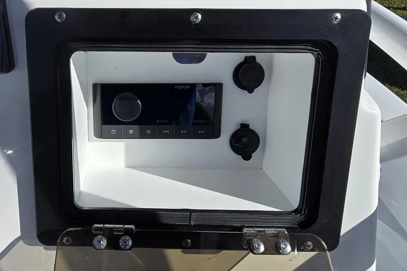 Slide: The Image of Control panel of 2026 NauticStar 224 Bay boat with audio system and power outlets. - 16