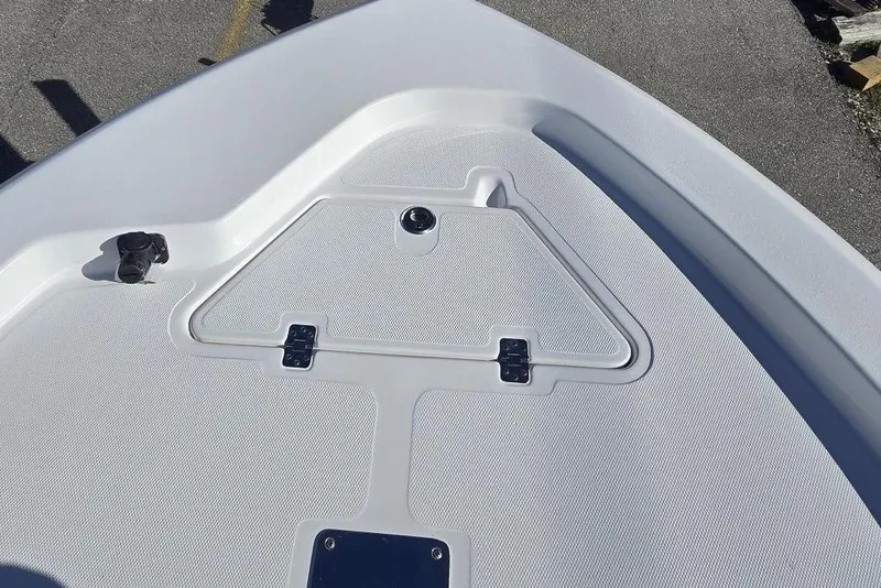 Slide: The Image of 2026 NauticStar 224 Bay boat deck with storage compartment and latch. - 24