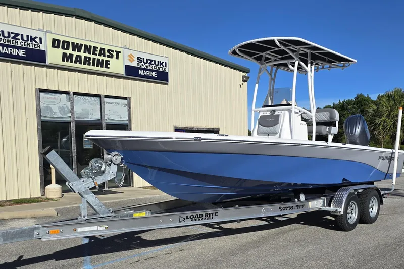 Slide: The Image of 2026 NauticStar 224 Bay boat on trailer outside Downeast Marine. - 26