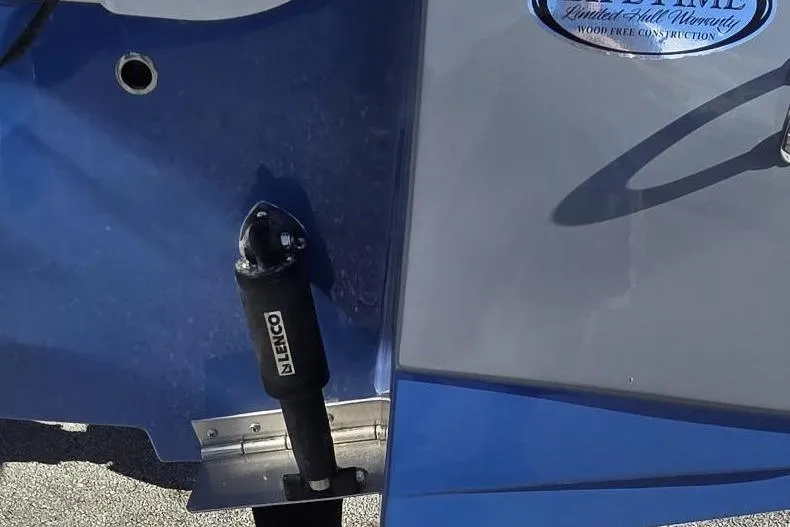 Slide: The Image of 2026 NauticStar 224 Bay boat detail with Lenco trim tab and warranty badge. - 3