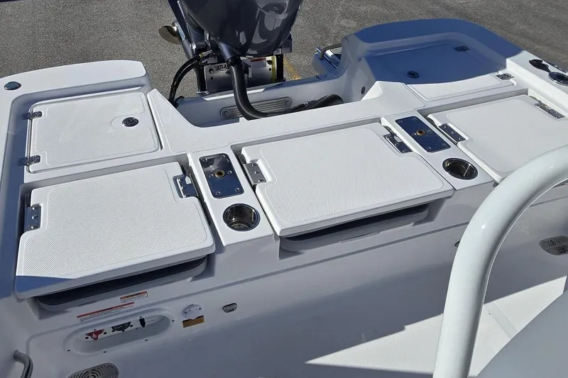 Slide: The Image of 2026 NauticStar 224 Bay boat deck with storage compartments and motor. - 5