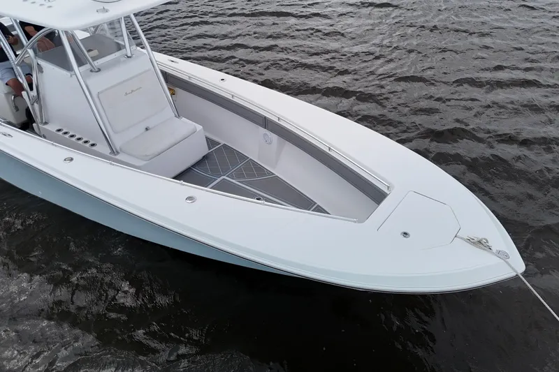 Slide: The Image of 2013 SeaHunter 33 Tournament boat with dual engines on open water. - 11