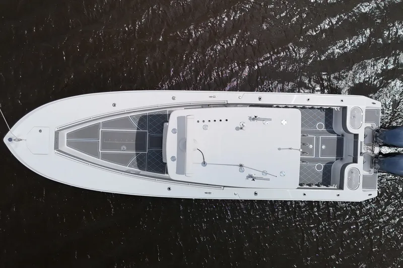 Slide: The Image of 2013 SeaHunter 33 Tournament boat on water, showcasing sleek design and spacious deck. - 12