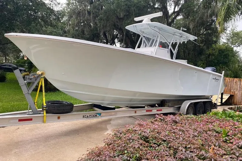 Slide: The Image of 2013 SeaHunter 33 Tournament boat on trailer, surrounded by lush greenery. - 15