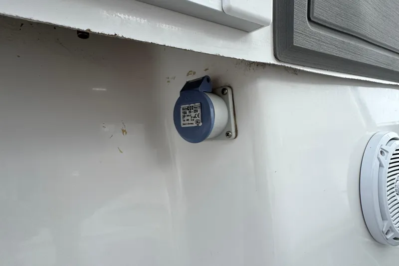 Slide: The Image of 2013 SeaHunter 33 Tournament boat with electrical outlet and speaker on white exterior. - 16