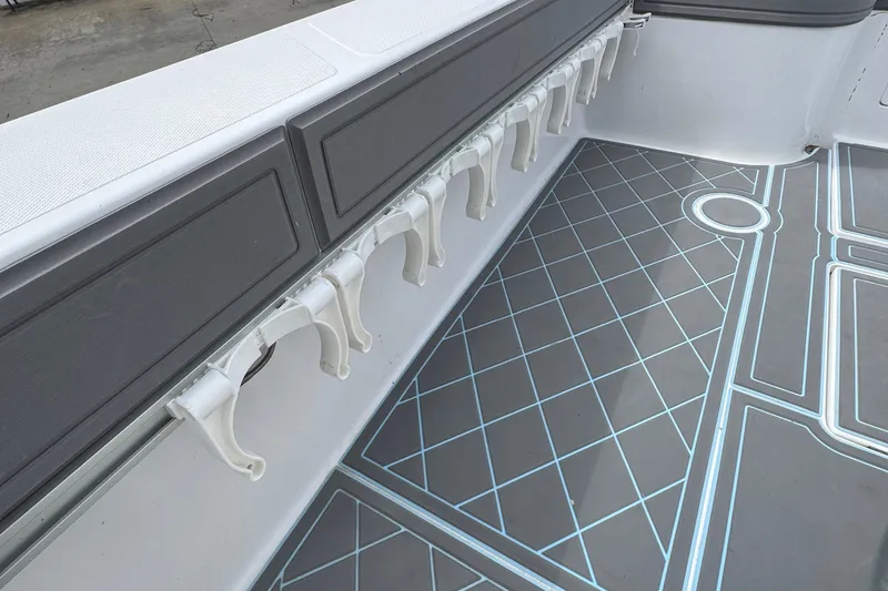 Slide: The Image of 2013 SeaHunter 33 Tournament boat interior with rod holders and geometric floor design. - 17