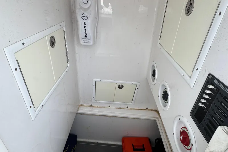 Slide: The Image of Interior of 2013 SeaHunter 33 Tournament boat with EPIRB and storage compartments. - 18