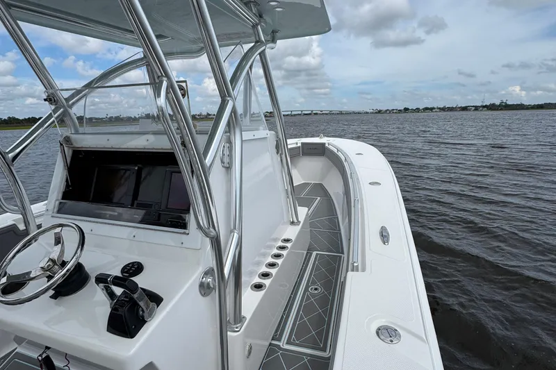 Slide: The Image of 2013 SeaHunter 33 Tournament boat on water, featuring sleek design and modern controls. - 21