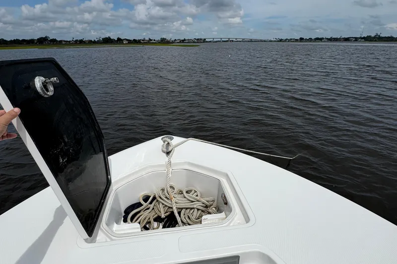 Slide: The Image of 2013 SeaHunter 33 Tournament boat with open anchor hatch on calm water. - 23