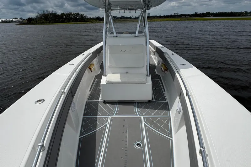 Slide: The Image of 2013 SeaHunter 33 Tournament boat on water, featuring spacious deck and sleek design. - 24
