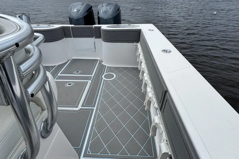 Slide: The Image of 2013 SeaHunter 33 Tournament boat deck with dual engines on calm water. - 27
