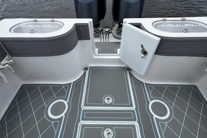 Slide: The Image of 2013 SeaHunter 33 Tournament boat deck with storage compartments and dual engines. - 29