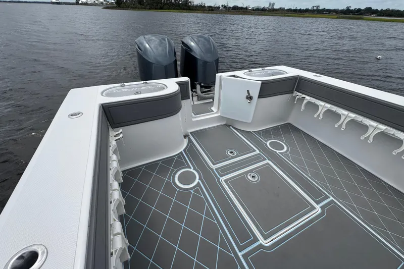 Slide: The Image of 2013 SeaHunter 33 Tournament boat deck with dual engines and fishing rod holders. - 30
