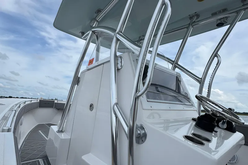 Slide: The Image of 2013 SeaHunter 33 Tournament boat console with steering wheel and stainless steel rails. - 34