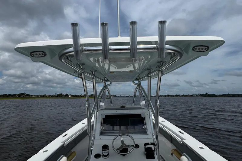 Slide: The Image of 2013 SeaHunter 33 Tournament boat on water, featuring helm and T-top under cloudy sky. - 41