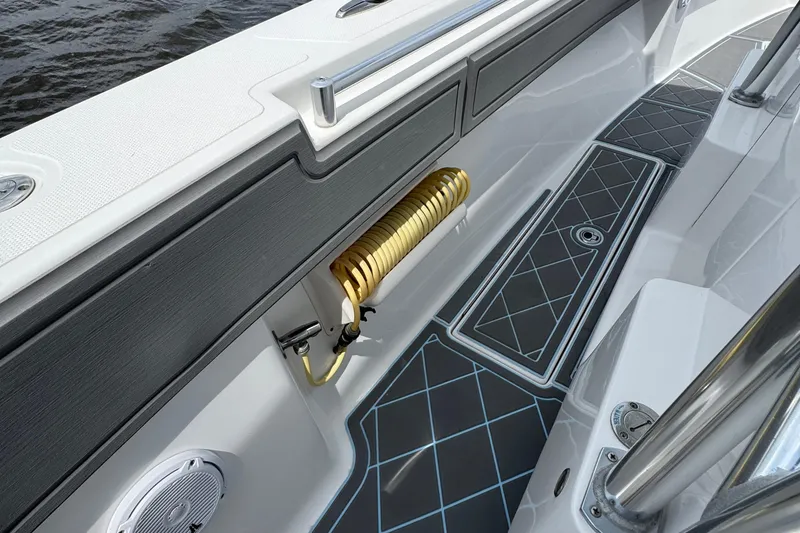 Slide: The Image of 2013 SeaHunter 33 Tournament boat interior with coiled hose and patterned flooring. - 42