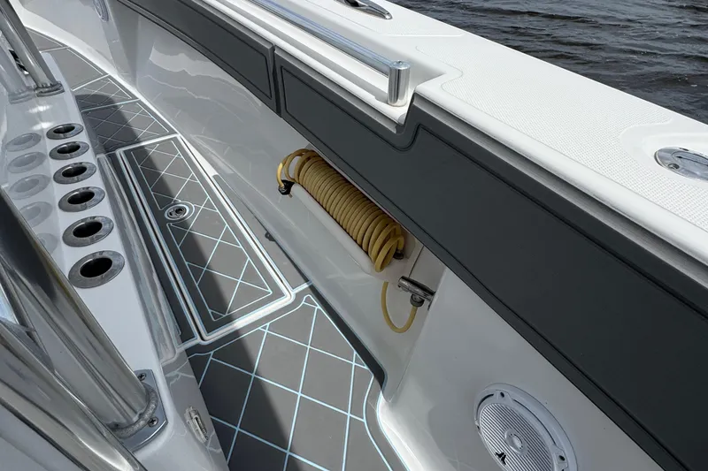 Slide: The Image of 2013 SeaHunter 33 Tournament boat deck with rod holders and coiled hose. - 43