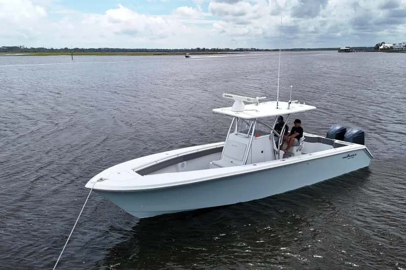 Slide: The Image of 2013 SeaHunter 33 Tournament boat cruising on a calm waterway. - 7