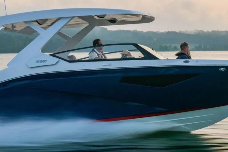 Slide: The Image of 2026 Yamaha Boats 295SD cruising on a serene lake at sunset. - 7