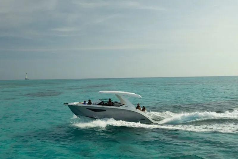 Slide: The Image of 2027 Yamaha Boats 295SD cruising on clear turquoise waters. - 6