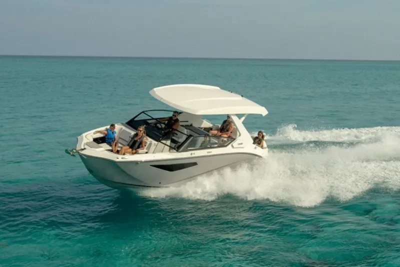 Slide: The Image of 2027 Yamaha Boats 295SD cruising on clear turquoise waters. - 4