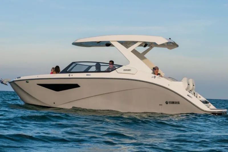 Slide: The Image of 2027 Yamaha Boats 295SD cruising on open water under clear skies. - 7