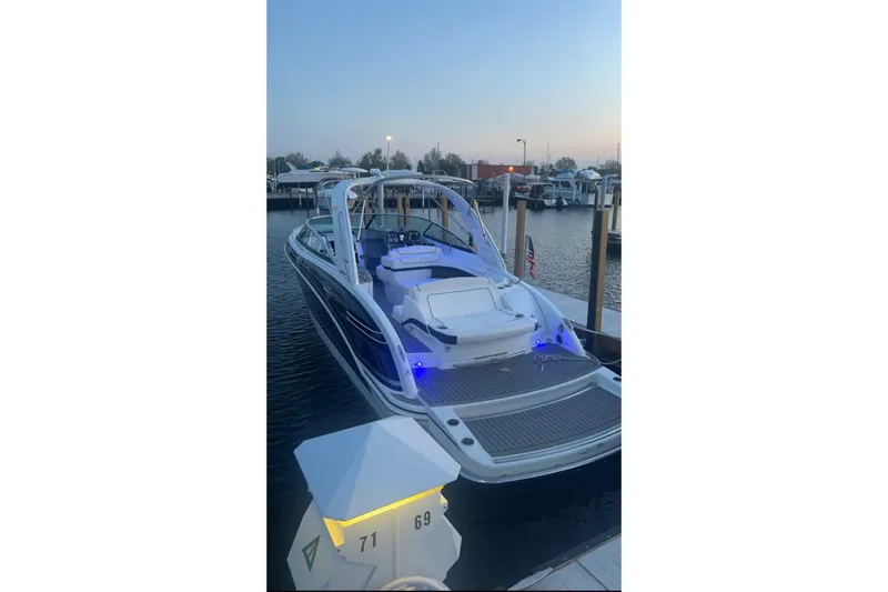 Slide: The Image of 2015 Formula 290 Sun Sport boat docked at marina during sunset. - 1