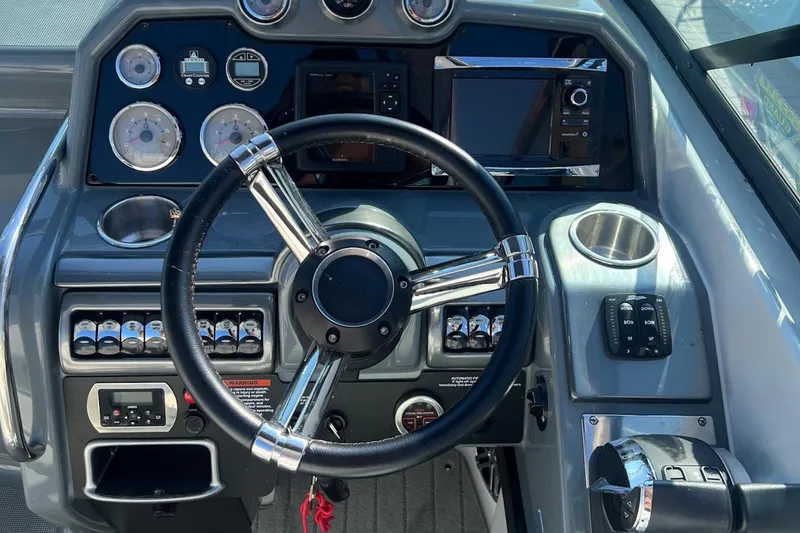 Slide: The Image of 2015 Formula 290 Sun Sport boat dashboard with steering wheel and control panel. - 3