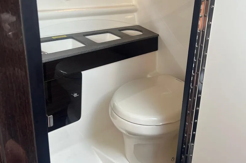 Slide: The Image of 2015 Formula 290 Sun Sport boat interior with white seating and cup holders. - 7