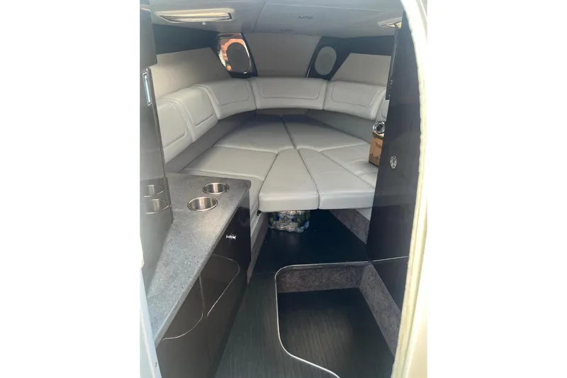 Slide: The Image of 2015 Formula 290 Sun Sport boat interior with storage cabinet and cup holders. - 9