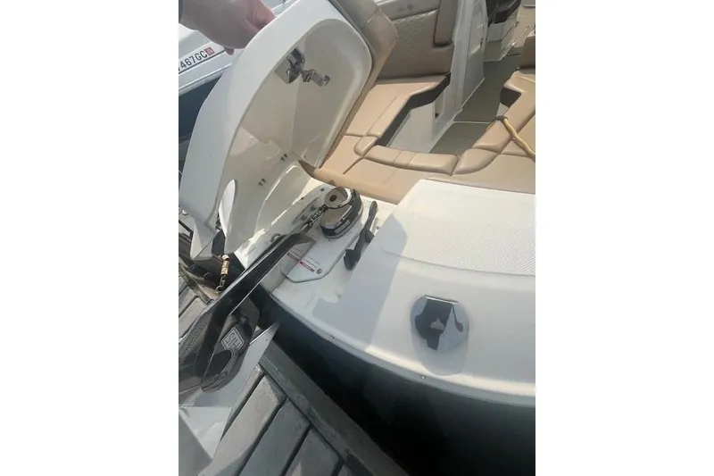 Slide: The Image of 2019 Sea Ray SDX 270 boat interior with open storage compartment and seating. - 13