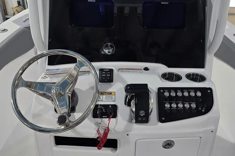 Slide: The Image of 2026 NauticStar 242L Offshore boat dashboard with steering wheel and control panel. - 14