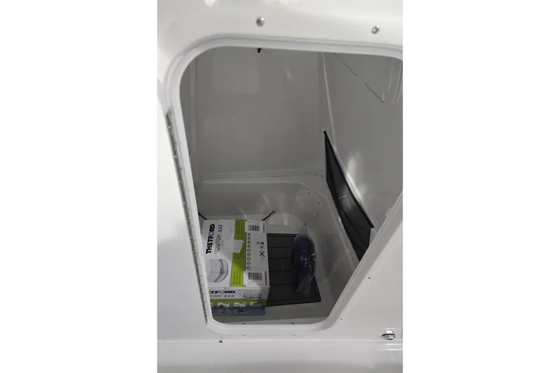 Slide: The Image of Storage compartment of 2026 NauticStar 242L Offshore boat with Thetford product box. - 17